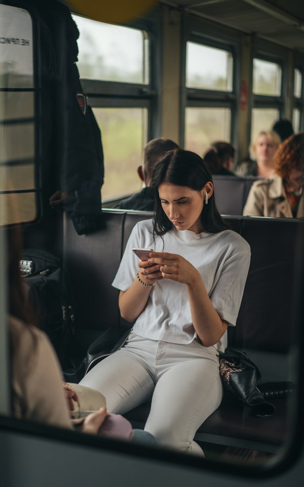 Student using her phone on a bus